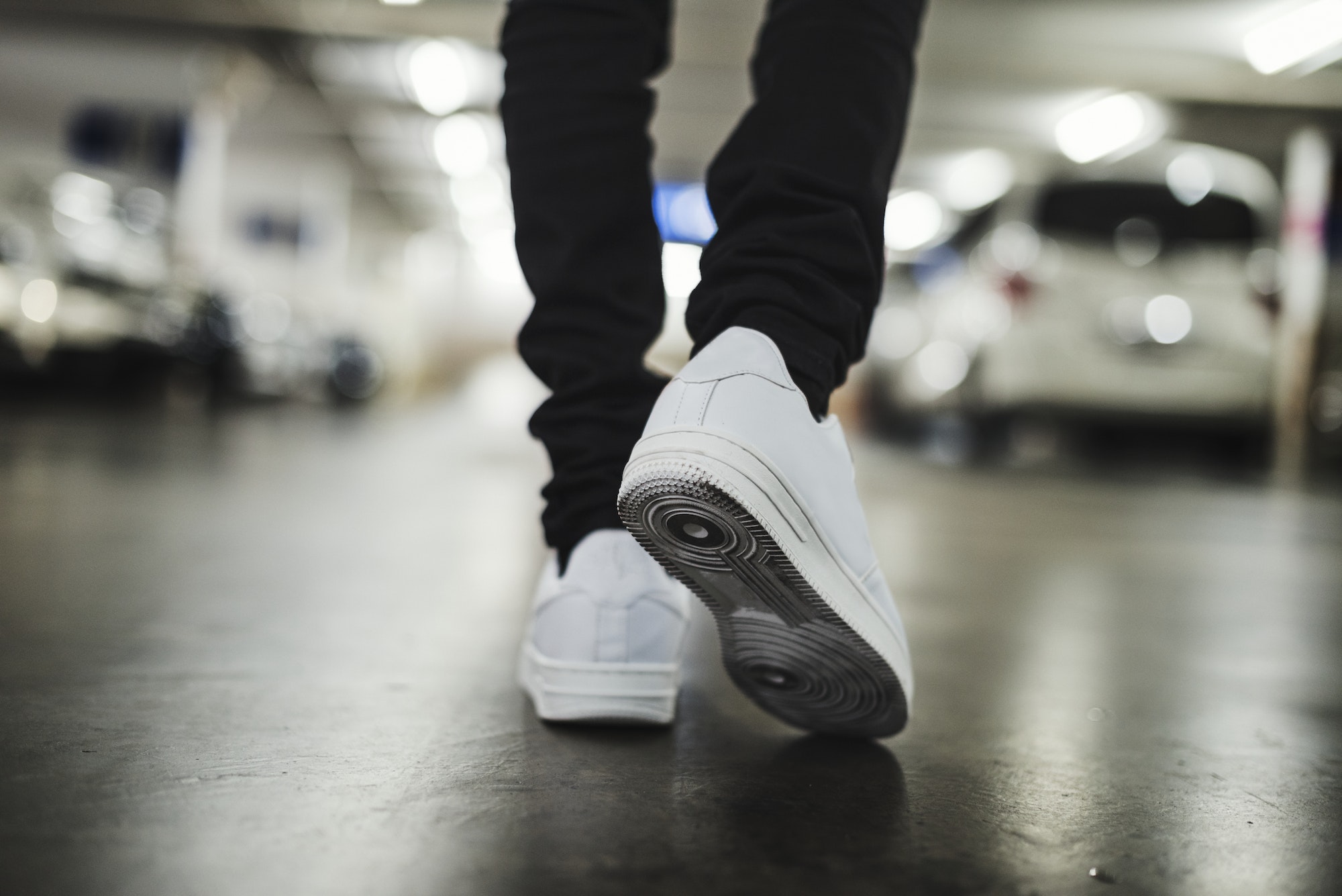 Man wearing jeans and sneakers in the parking lot